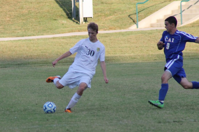 Sophomore Zach Yagle passes the ball in the soccer game against Christian Academy of Indiana. The Highlanders won 2-0. Photo by Braden Schroeder.